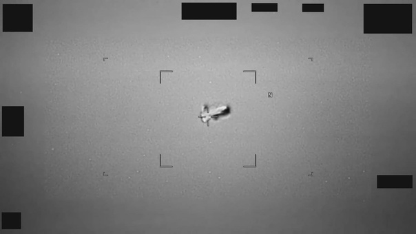 Blurred military image of a football-shaped object reported as a UAP near Japan.